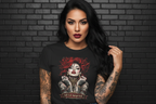 Woman in Soft but Dangerous Performance Tee activewear featuring a graphic of a tattooed woman against a black brick wall.