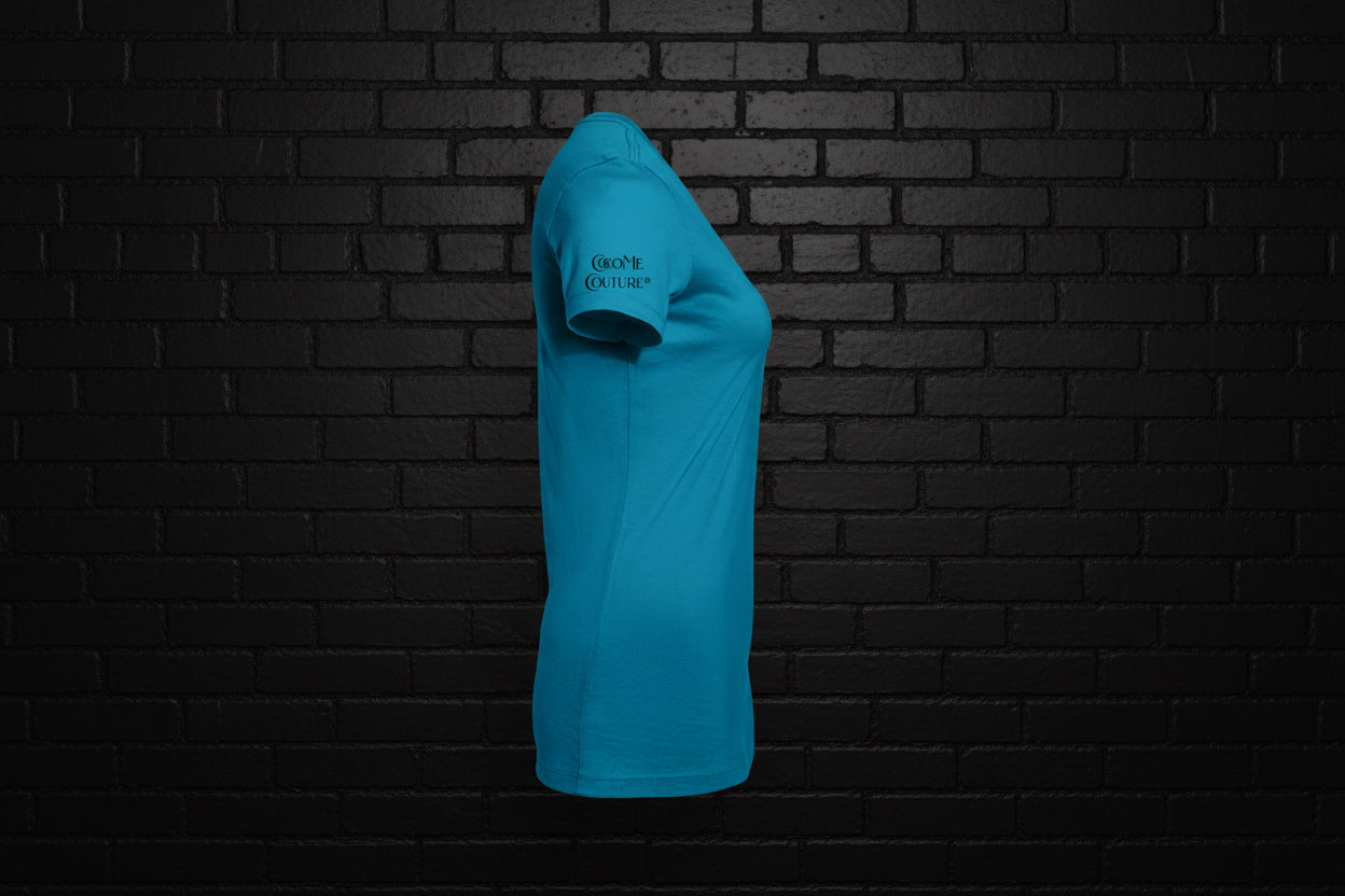 Side view of women's turquoise No Talking slim fit graphic tee in premium cotton on a black brick wall background.
