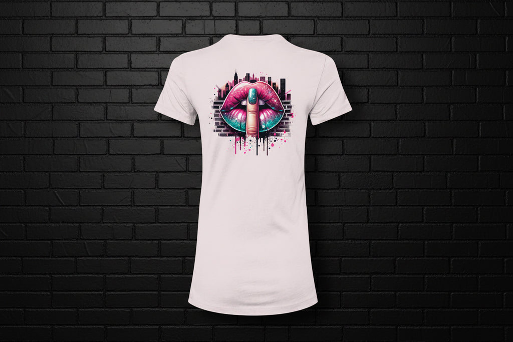Back view of a white women’s slim fit cotton tee featuring a vibrant shushing lips graphic against a black brick wall.