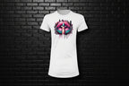 White Women's Slim Fit Graphic Tee with pink lip and finger 'shh' design against a black brick wall background.