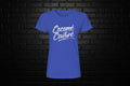 Cocome Couture premium royal blue cotton tee with white script logo on a black brick background.