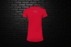 Back view of the red Cocome Couture Breathe Luxury slim fit tee with brand logo against a black brick background.
