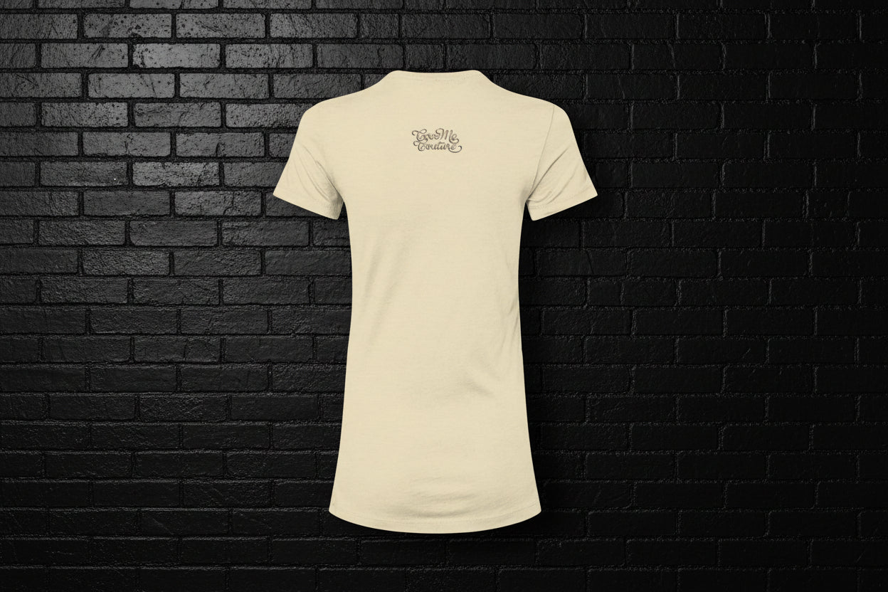 Back view of the Breathe Luxury Slim Fit Tee in cream featuring the Cocome Couture logo on a black brick background.