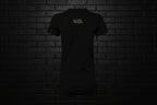 Back view of the Breathe Luxury Slim Fit Tee in black featuring a white Cocome Couture logo against a black brick wall.