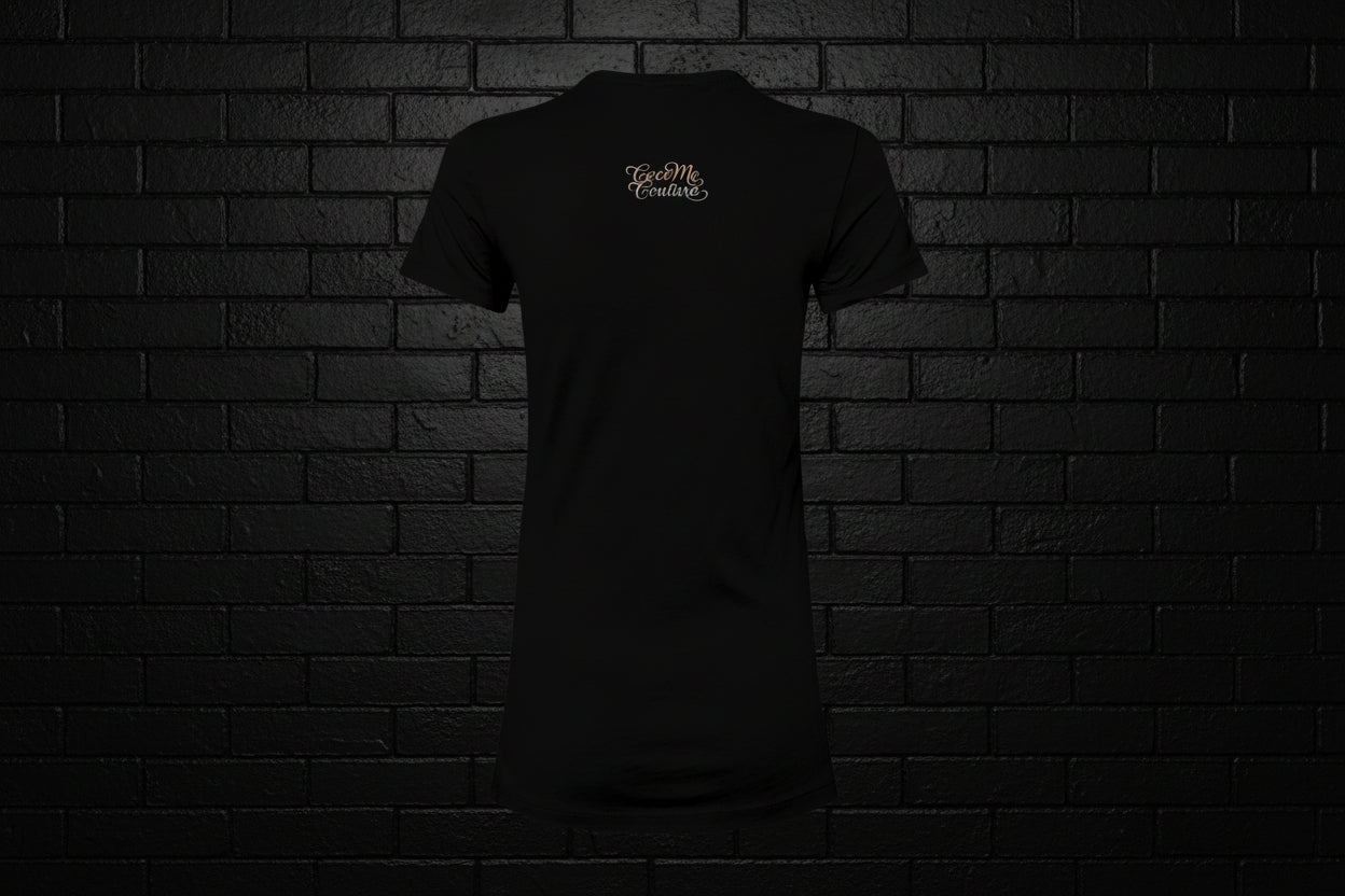 Back view of the Breathe Luxury Slim Fit Tee in black featuring a white Cocome Couture logo against a black brick wall.