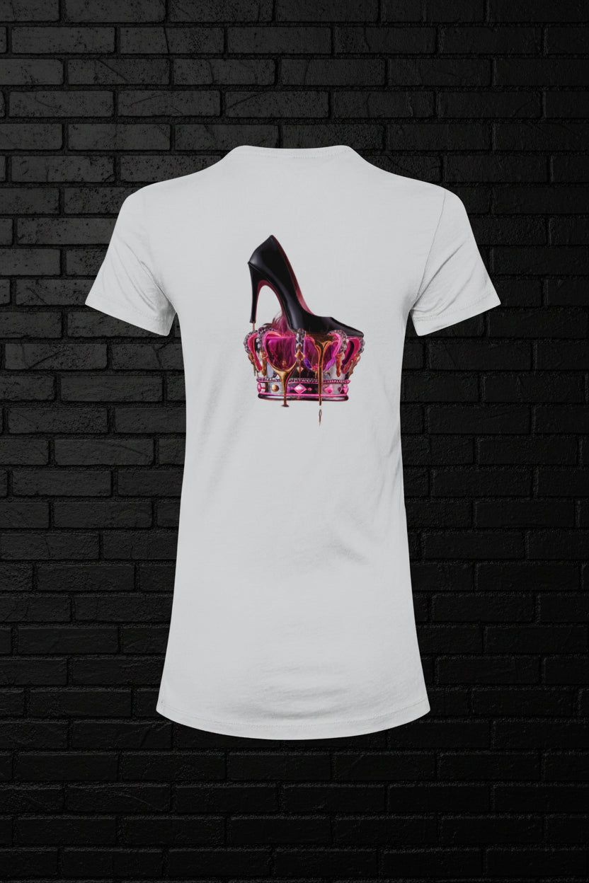 White Royal Rebellion graphic tee with a black stiletto on a molten pink and gold crown against a dark brick wall.