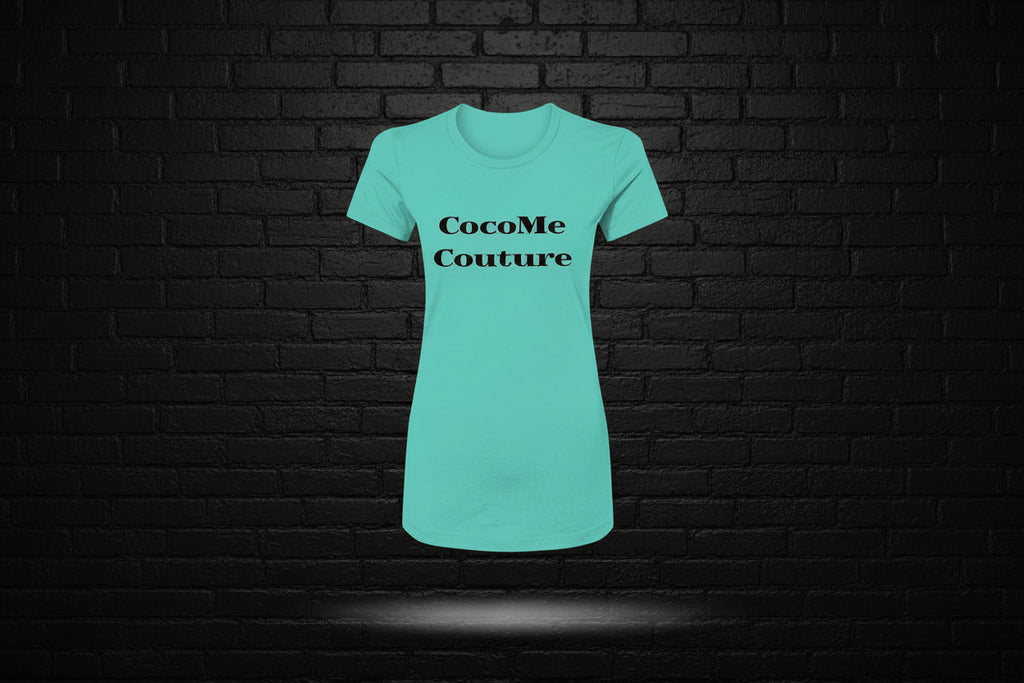 Teal Royal Rebellion Graphic Tee featuring black CocoMe Couture text, displayed against a black brick wall background.