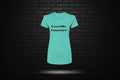 Teal Royal Rebellion Graphic Tee featuring black CocoMe Couture text, displayed against a black brick wall background.