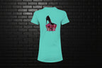 Royal Rebellion Graphic Tee in teal featuring a black stiletto on a molten pink and gold crown, shown against a brick wall.