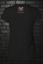 Back view of black Soft but Dangerous Performance Tee featuring rose gold Cocome Couture logo on a brick background.