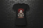 Women's black Soft but Dangerous Performance Tee with red-haired gothic graphic on a brick background.