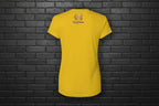 Back view of Soft but Dangerous Women's Activewear Performance Tee in gold with Cocome Couture logo on black brick.