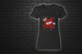 Women's black cotton graphic tee with Pretty But A Problem crown and lips design against a dark brick wall.