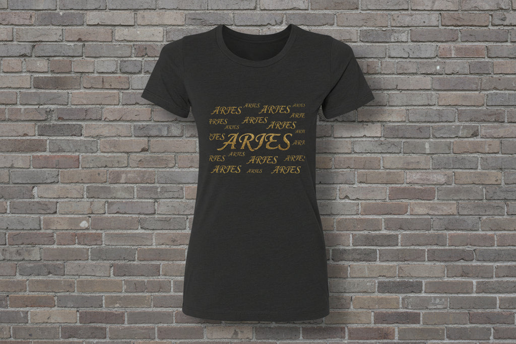 Aries the Ram Premium Tee in black featuring a gold metallic astrology graphic on a brick wall background.