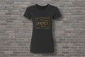 Aries the Ram Premium Tee in black featuring a gold metallic astrology graphic on a brick wall background.
