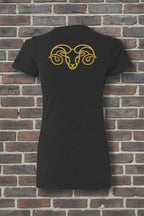 Back of black Aries the Ram Premium Tee featuring a gold glitter zodiac graphic on a textured brick background.