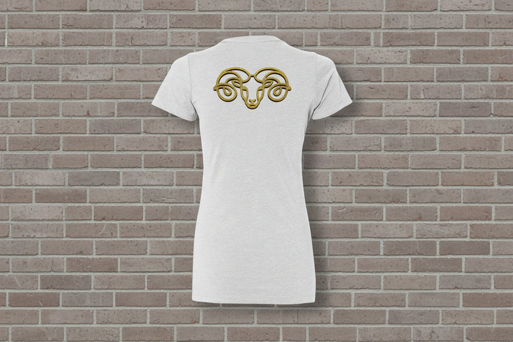 Back view of Aries the Ram Premium Tee in white with a gold zodiac astrology graphic on a brick wall background.