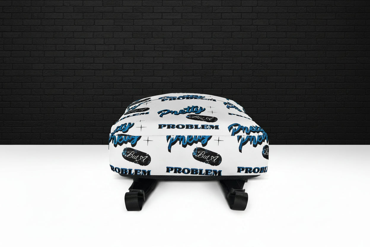 Bottom view of Pretty But A Problem water-resistant laptop backpack with white graphic print and black straps.