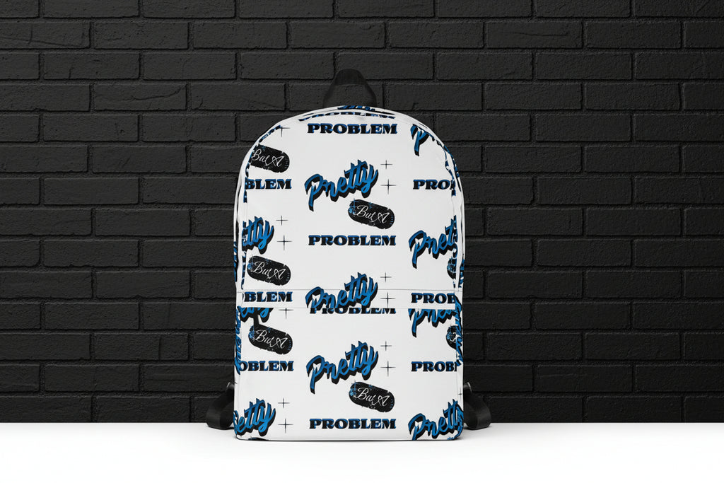 White Pretty But A Problem laptop backpack with blue graphic print on a black brick background for school and travel.