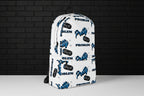White water-resistant 15-inch laptop backpack with blue and black graphic print against a dark brick wall.