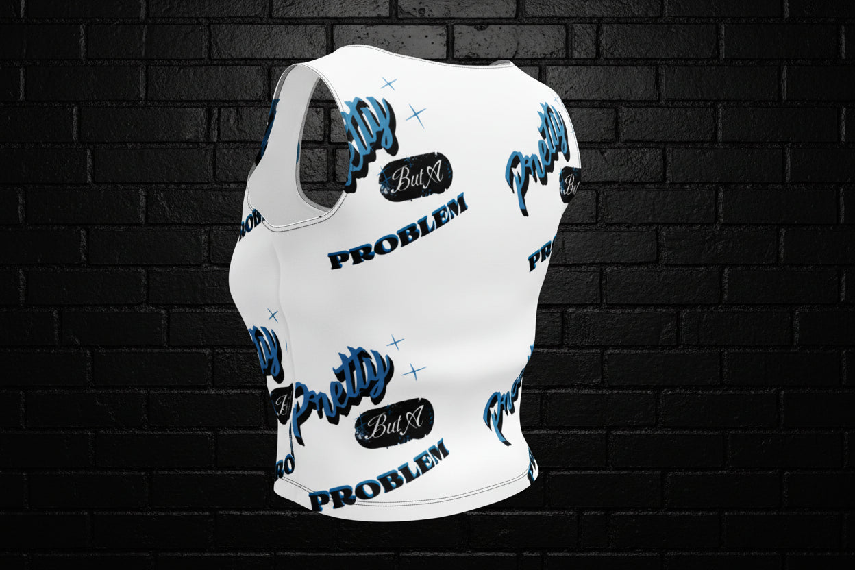 Back view of a white women's graphic crop top with blue and black text against a dark brick wall.