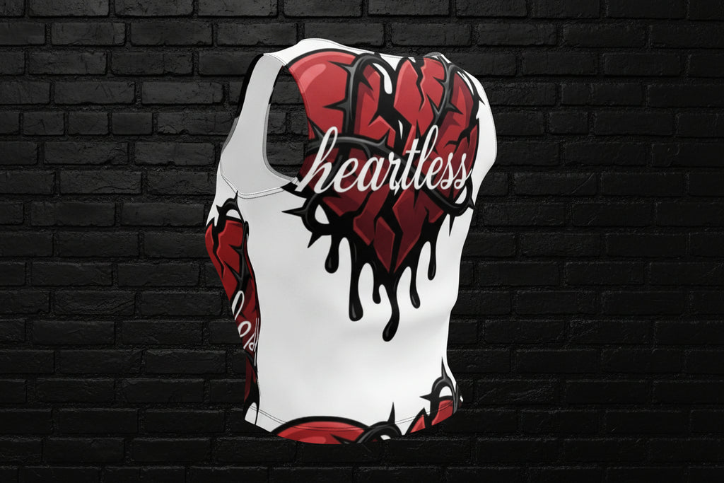 Back of women's Heartless crop top streetwear with red dripping heart and barbed wire print on a black brick background.