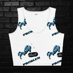 Women's white graphic crop top with blue 'Pretty But A Problem' text pattern and scoop neck on a black brick background.