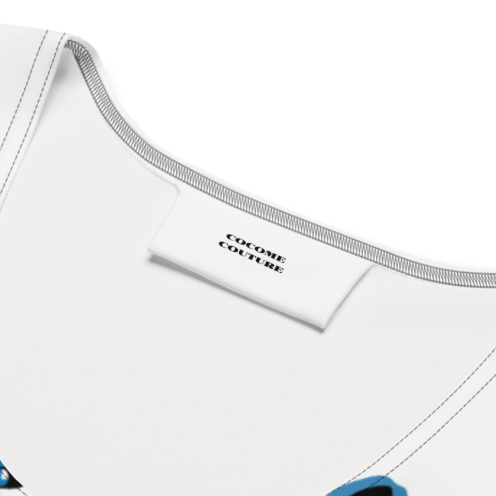 Close-up of Cocome Couture brand label on the inner neckline of a white women's graphic crop top with premium stitching.
