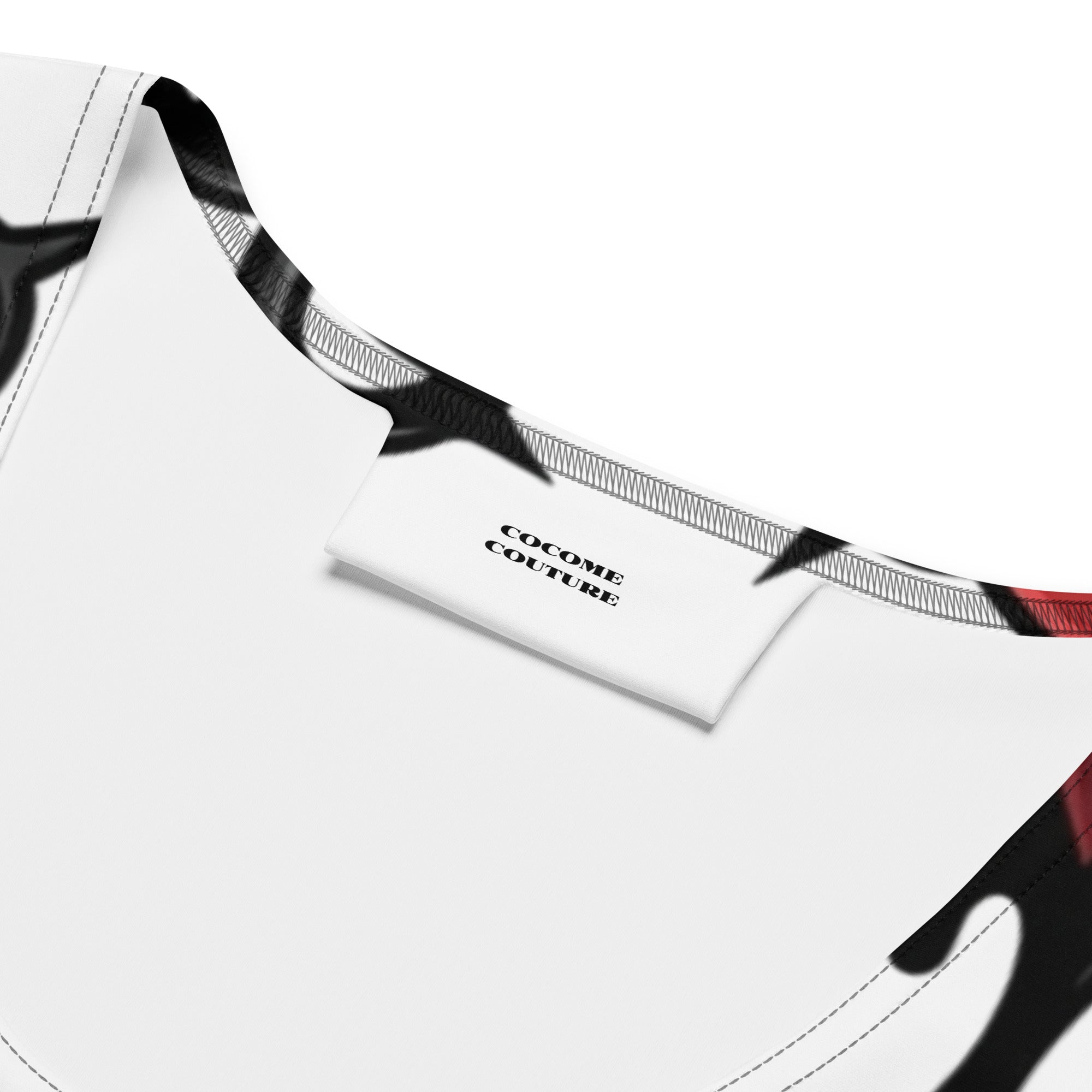 Close-up of the Cocome Couture brand label and ribbed neckline on the Heartless women's streetwear crop top.