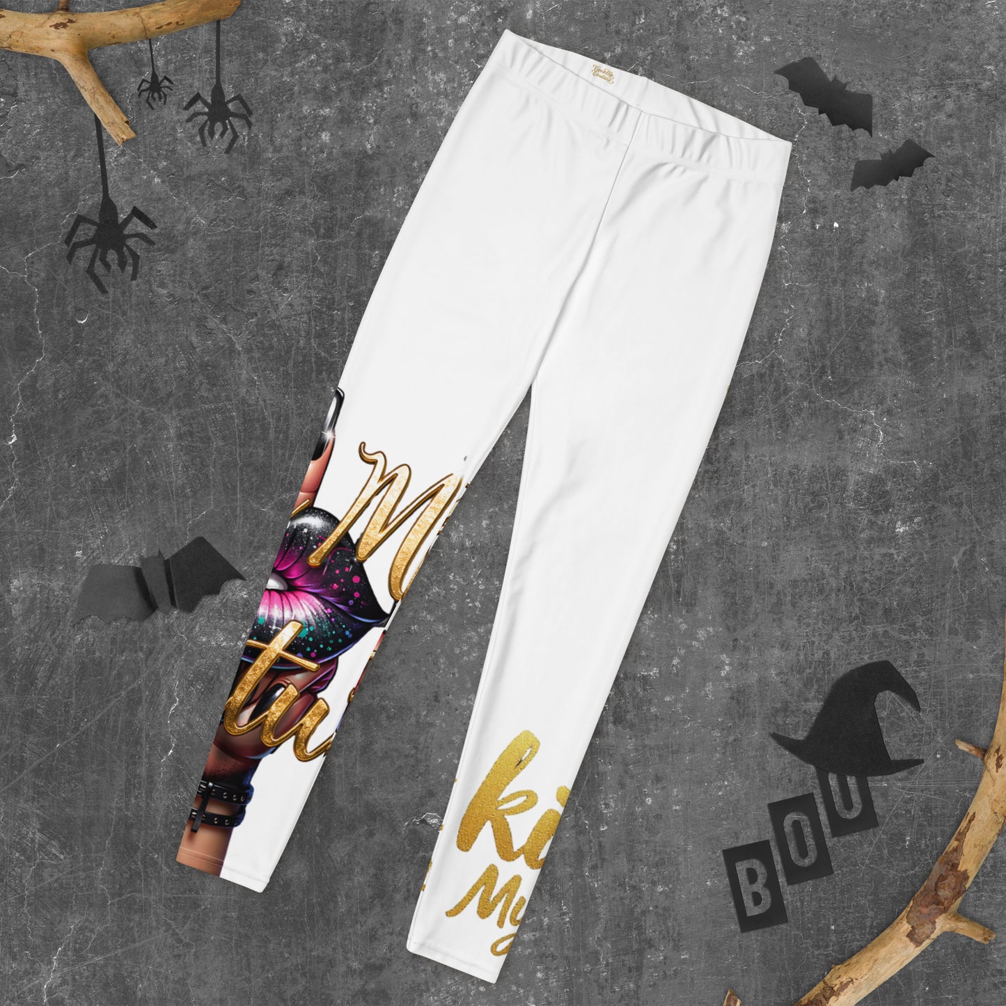 Kiss My Couture Leggings with bold lip graphic and glittery gold text on white fabric, perfect for stylish activewear or casual fashion looks.