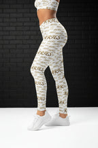 Side view of model in Golden Aries high waisted yoga leggings with all-over zodiac print on white microfiber yarn.