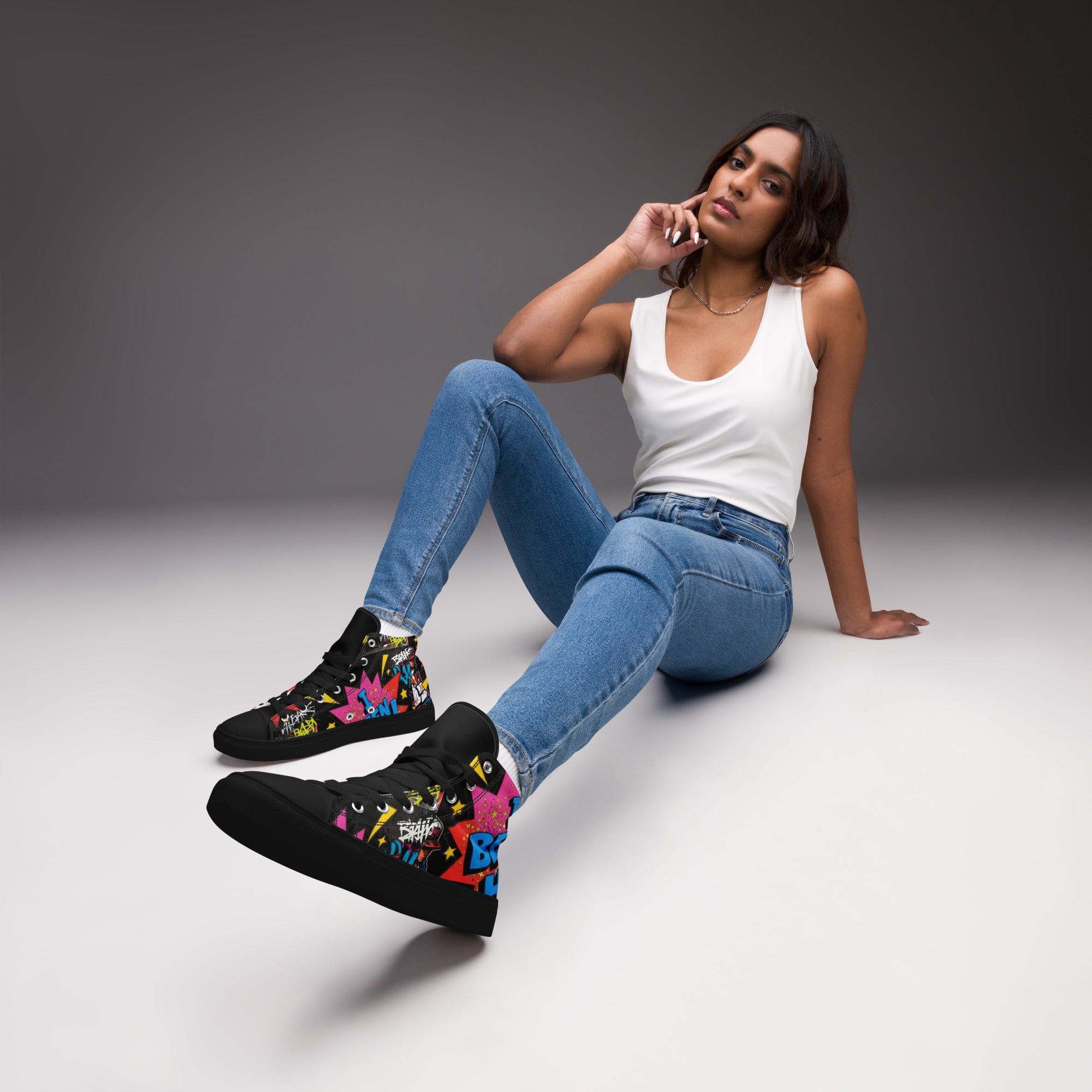 Lifestyle view of a woman wearing Cocome Couture 'I Been Her' black graffiti print high top canvas sneakers.